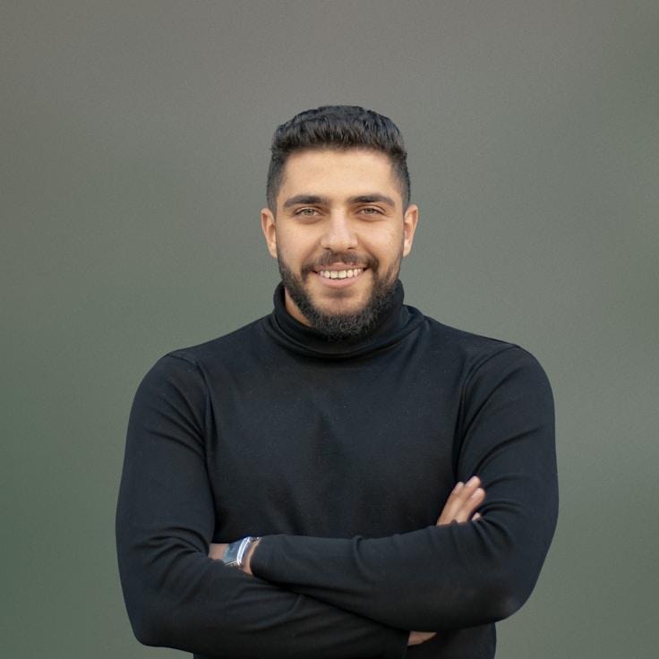 Avery Singh, Lead Design Curator at BreezeHarborLilt, reviewing corporate floral arrangements